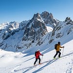 Skiers navigating the challenging Pierra Menta mountain route with stunning alpine scenery