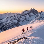 Skiers navigating the glaciers of Écrins during the Grande Ruine raid